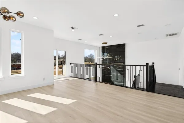 a view of a living room with wooden floor