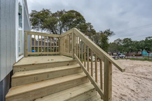 a view of a dirt road with a building in the background