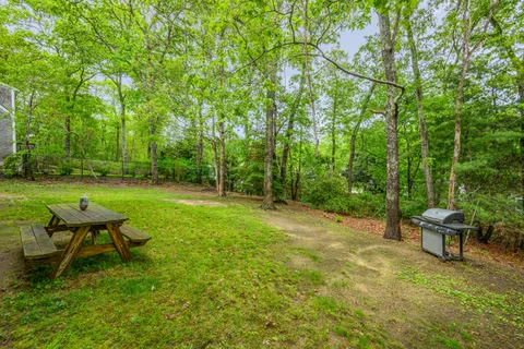 a backyard of a house with table and chairs