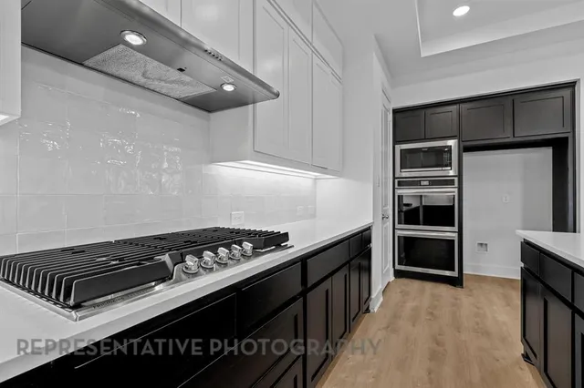 a kitchen with granite countertop a stove and a refrigerator