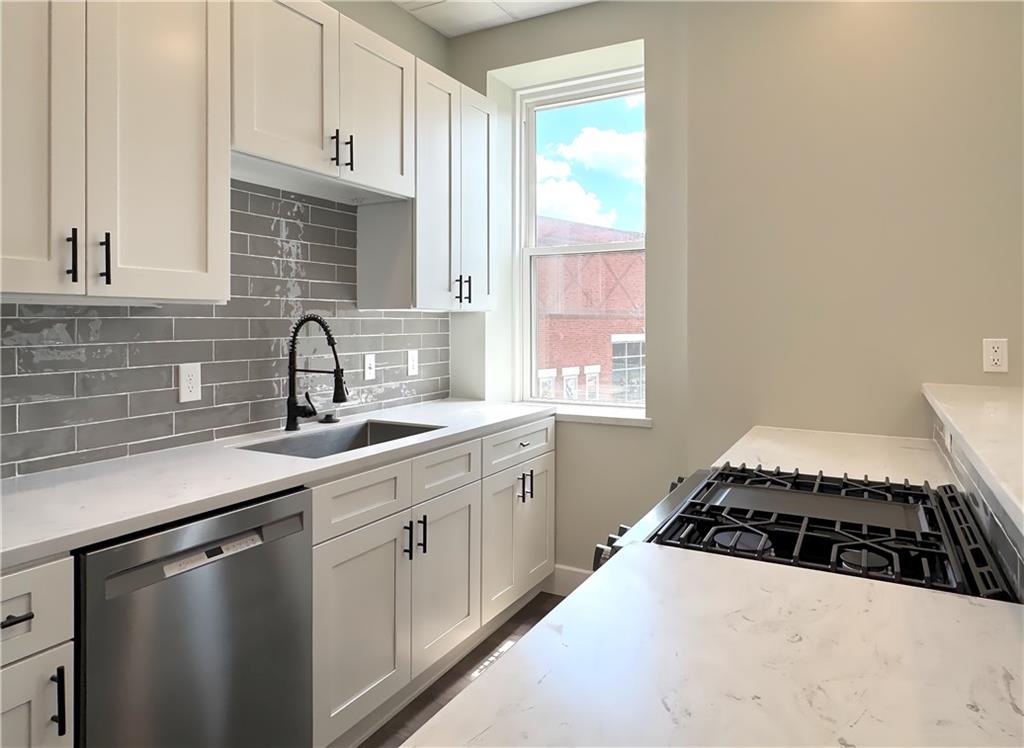 422 Walnut Street, Unit 2 Sewickley, PA 15143 - Photo 3 of 12 a kitchen with a sink and a stove