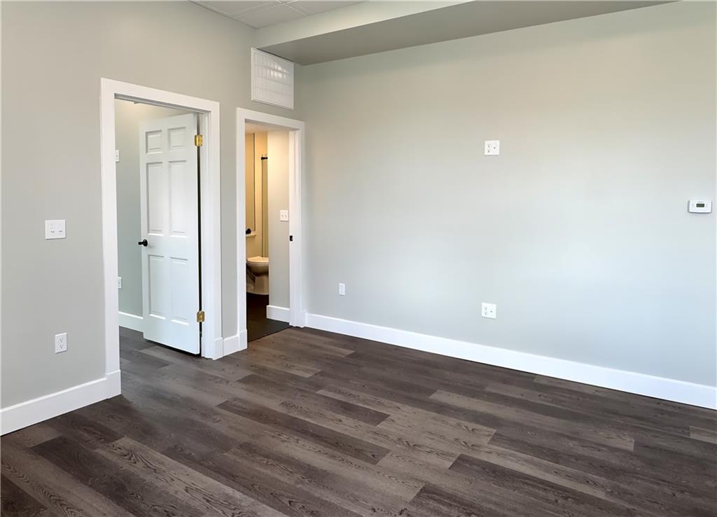 422 Walnut Street, Unit 2 Sewickley, PA 15143 - Photo 4 of 12 a view of an empty room with wooden floor and closet
