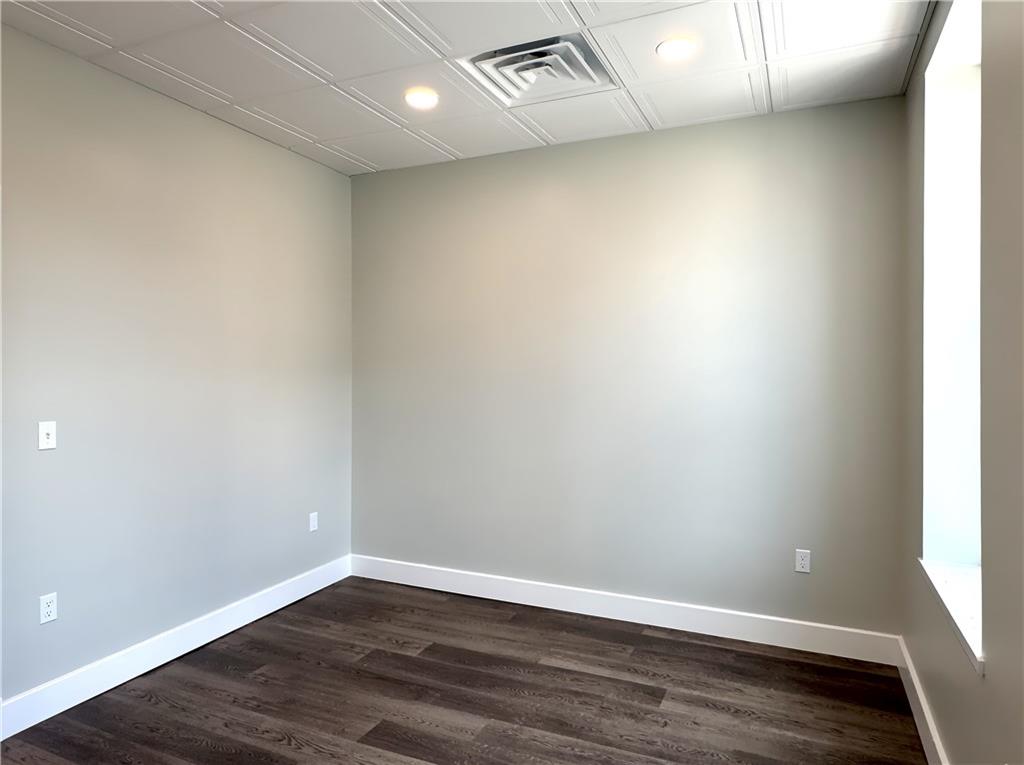 422 Walnut Street, Unit 2 Sewickley, PA 15143 - Photo 7 of 12 an empty room with wooden floor and windows