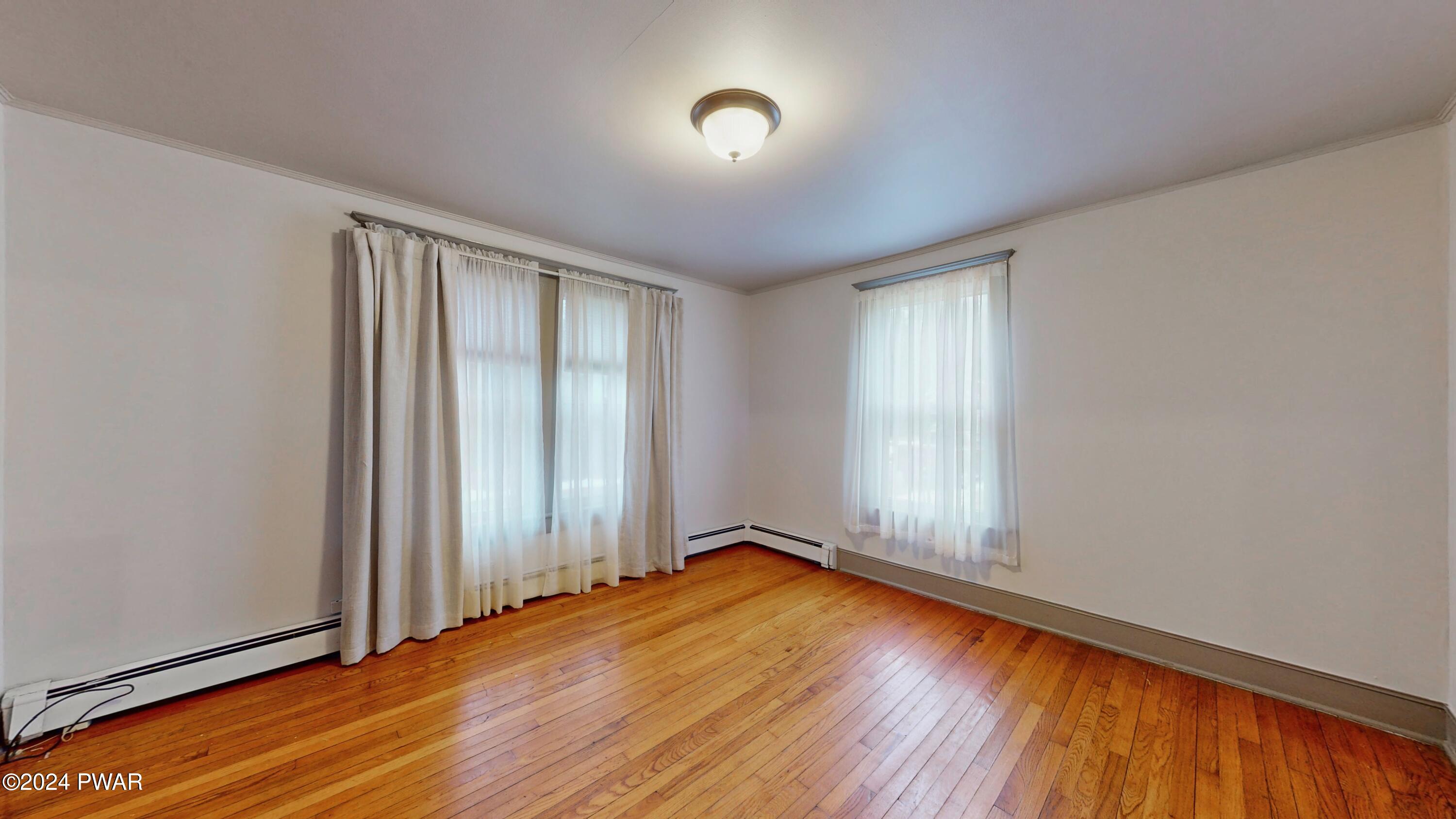 108 9th Street Milford, PA 18337 - Photo 8 of 38 an empty room with wooden floor and windows