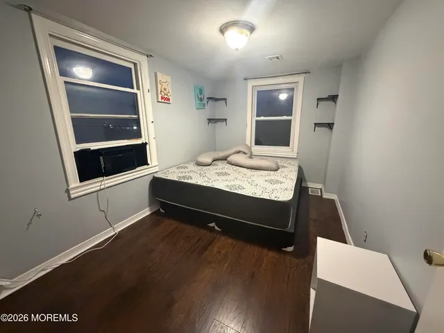 a bedroom with a bed and lamp