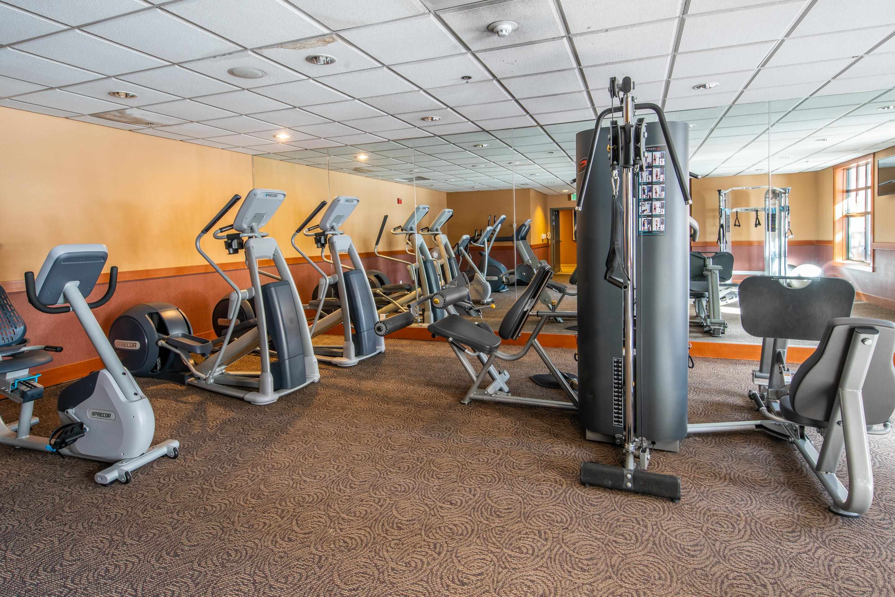6201 Minaret Road, Unit 2328 Mammoth Lakes, CA 93546 - Photo 23 of 23 Fitness center featuring a variety of exercise equipment, wall-mounted mirrors, and patterned carpet flooring