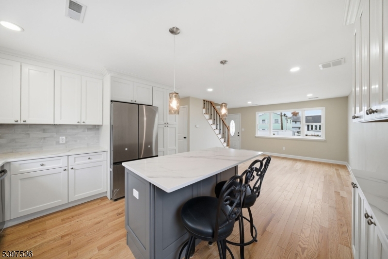 2535 Standish Avenue Union, NJ 07083 - Photo 11 of 45 a kitchen with stainless steel appliances a table chairs and refrigerator