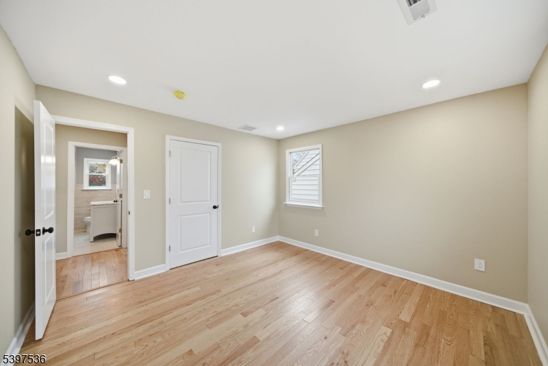 2535 Standish Avenue Union, NJ 07083 - Photo 13 of 45 a view of an empty room with wooden floor and a window