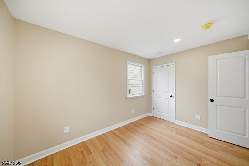 2535 Standish Avenue Union, NJ 07083 - Photo 22 of 45 a view of an empty room with wooden floor and a window