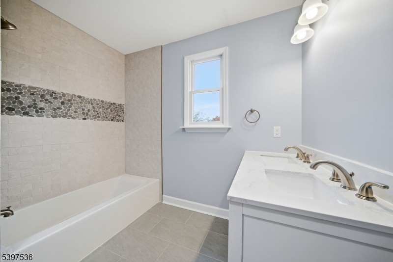2535 Standish Avenue Union, NJ 07083 - Photo 23 of 45 a bathroom with a tub sink and mirror