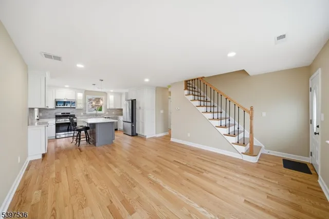a view of a kitchen with furniture and wooden floor