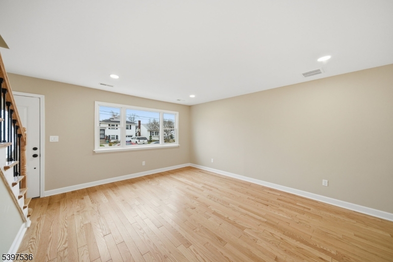 2535 Standish Avenue Union, NJ 07083 - Photo 6 of 45 an empty room with wooden floor and windows