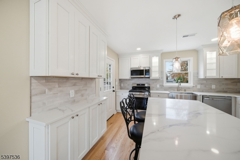 2535 Standish Avenue Union, NJ 07083 - Photo 8 of 45 a kitchen with stainless steel appliances a sink a stove top oven a counter space and cabinets