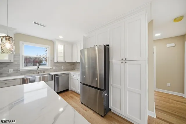 a kitchen with a refrigerator and a sink