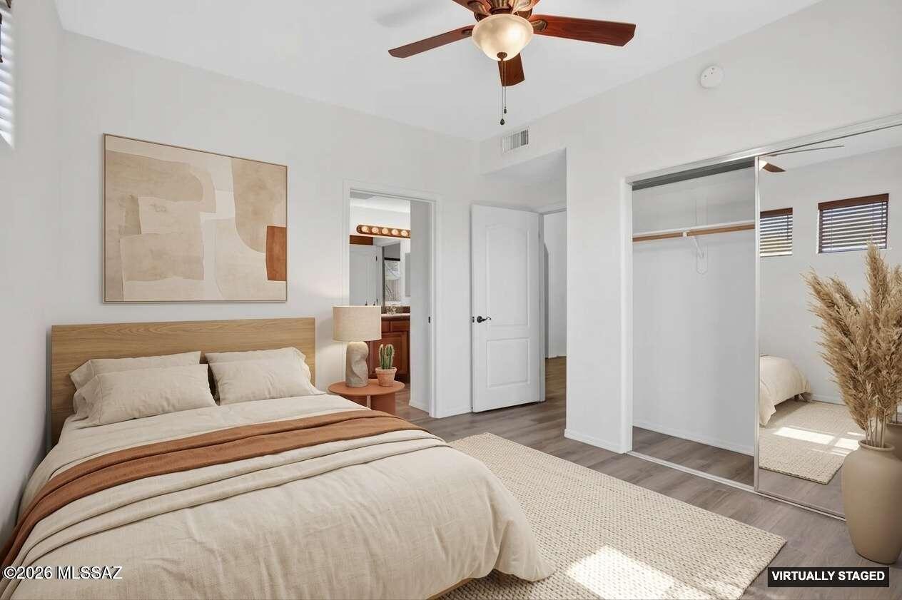 2550 East River Road, Unit 4204 Tucson, AZ 85718 - Photo 27 of 36 a bedroom with a large bed and a chandelier