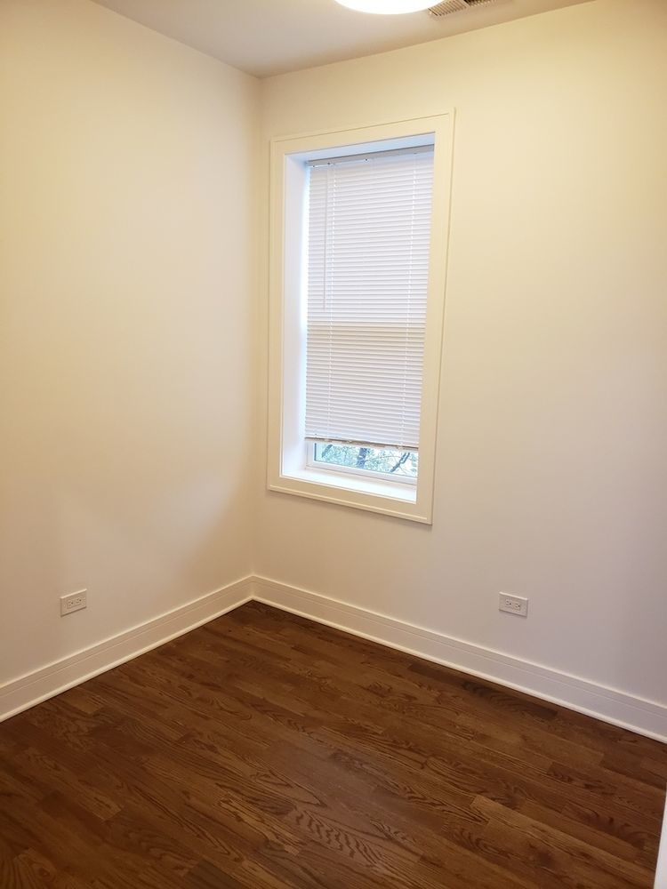 2347 West Taylor Street, Unit 3R Chicago, IL 60612 - Photo 5 of 9 a view of an empty room with wooden floor and a window