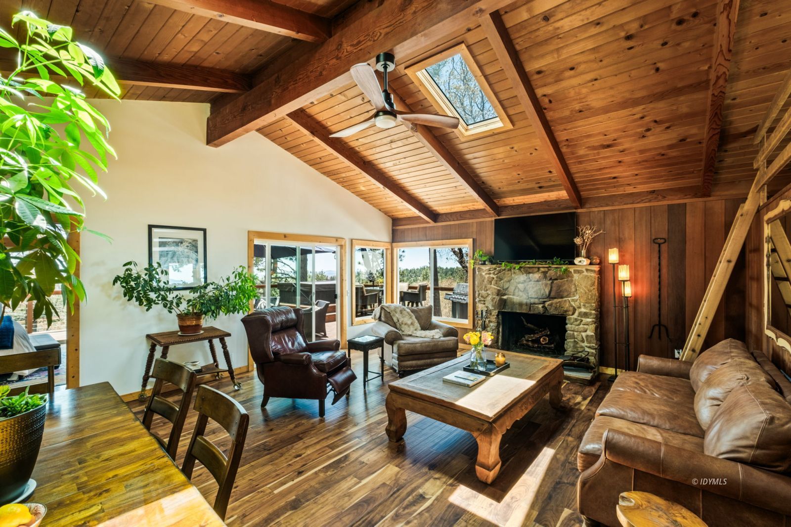 24750 Marion Ridge Drive Idyllwild, CA 92549 - Photo 6 of 45 a living room with furniture a fireplace and a potted plant