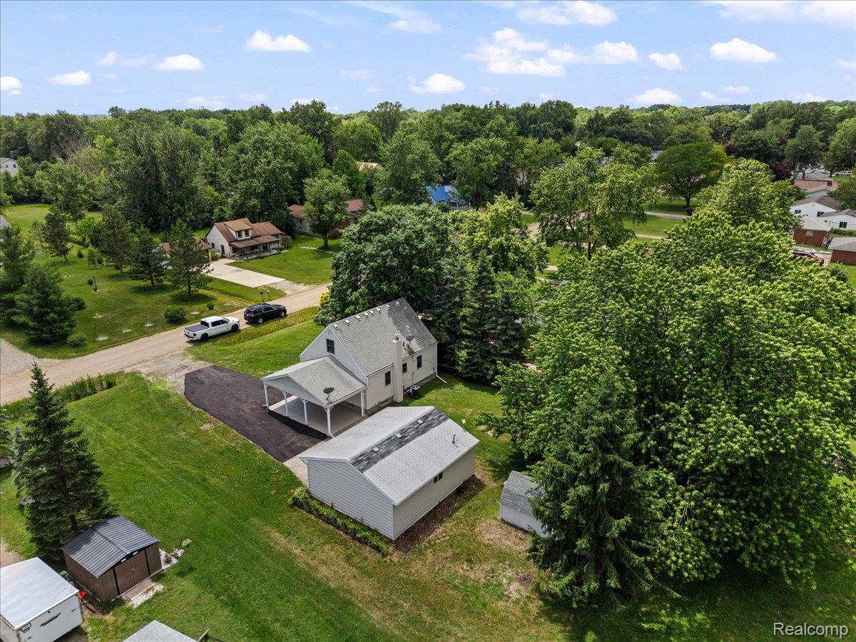 43600 Crowley Road Belleville, MI 48111 - Photo 31 of 33 Expansive property featuring a two-story residence with an attached carport, a detached outbuilding, and mature trees on a large lot