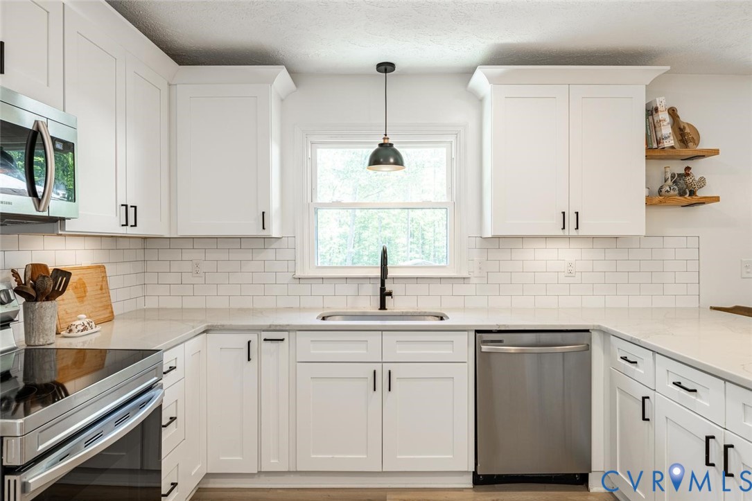 12397 New Market Mill Road Beaverdam, VA 23015 - Photo 11 of 44 a kitchen with white cabinets and white appliances