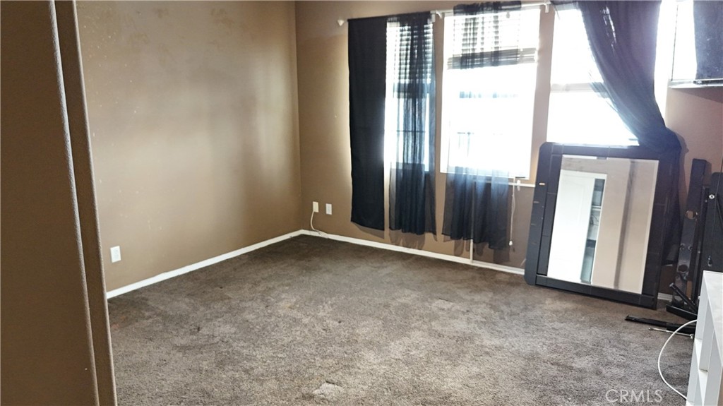 176 Nightfall Road San Jacinto, CA 92582 - Photo 6 of 11 an empty room with windows