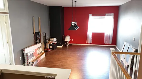 a view of a living room with furniture and wooden floor