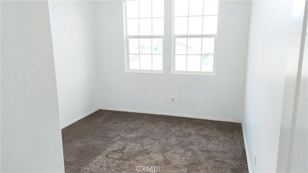 176 Nightfall Road San Jacinto, CA 92582 - Photo 10 of 11 an empty room with a window