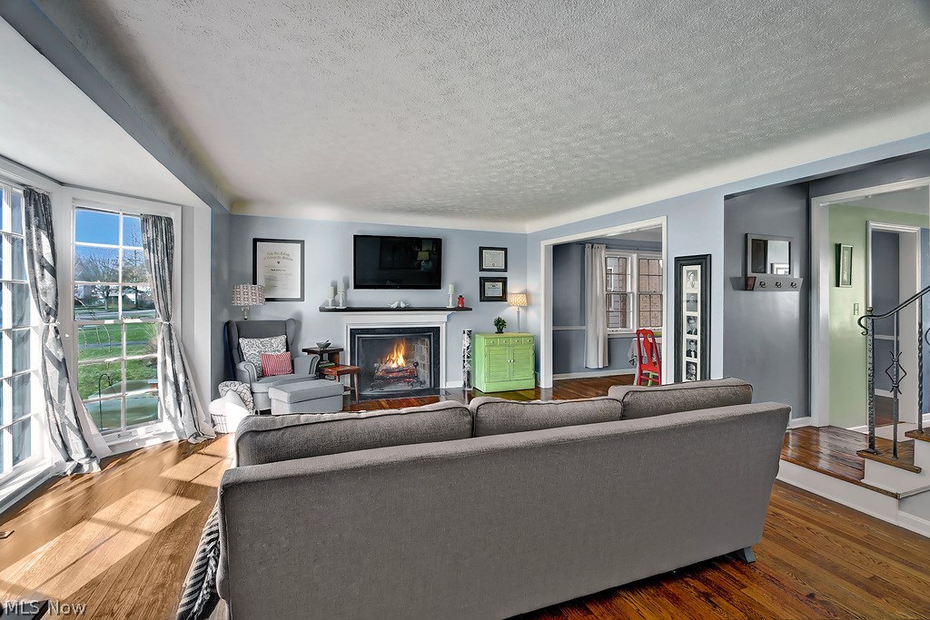 3693 Gridley Road Shaker Heights, OH 44122 - Photo 2 of 22 Living Room with Refinished Hardwood Floors, Fireplace, Bay Window & Wall Mounted T.V.