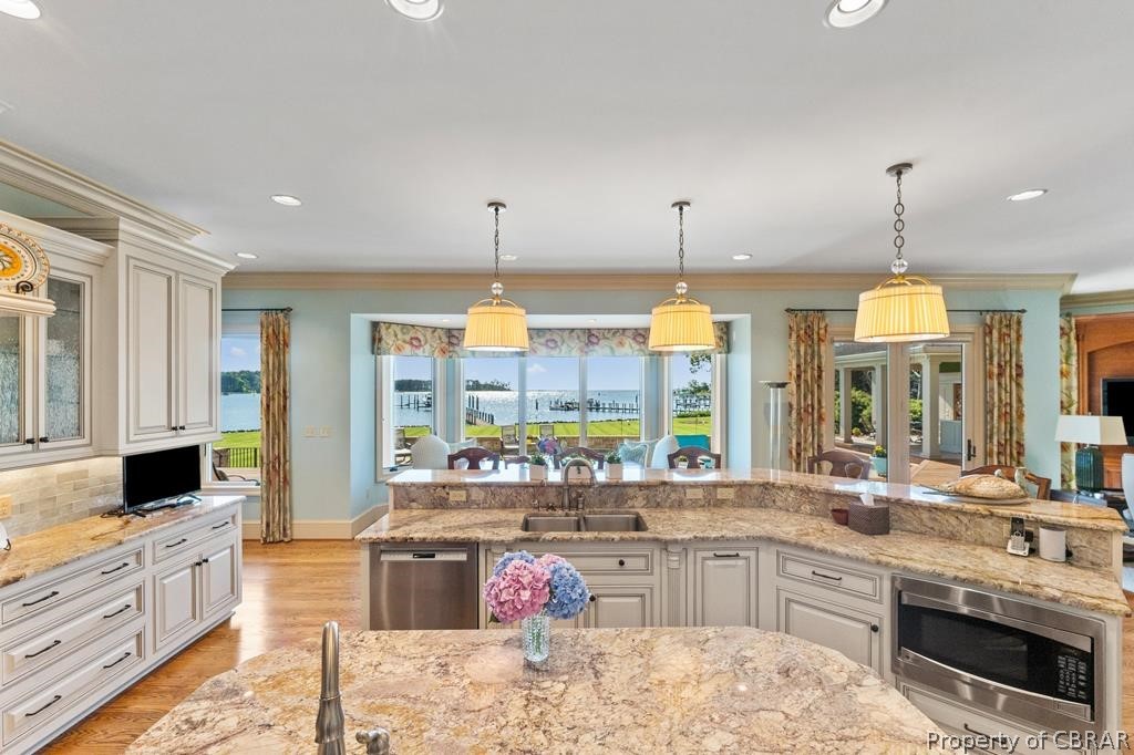 2055 Ditchley Road Kilmarnock, VA 22482 - Photo 21 of 48 Kitchen with hanging light fixtures, sink, a wealth of natural light, and stainless steel appliances
