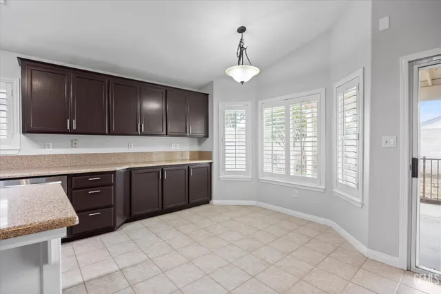 a kitchen with a sink window and cabinets