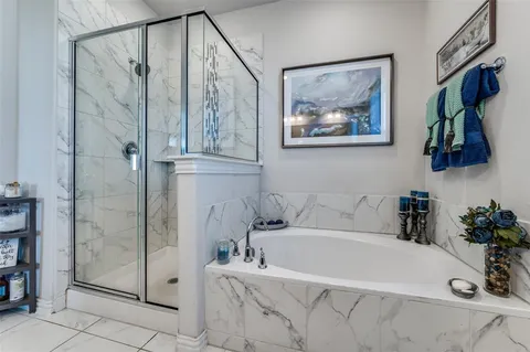 a bathroom with a tub and shower