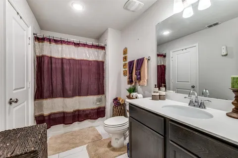 a bathroom with a double vanity sink toilet and shower