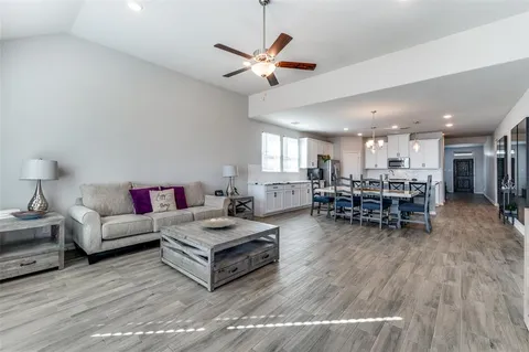 a living room with furniture and kitchen view