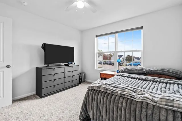 a spacious bathroom with a double vanity sink toilet and mirror