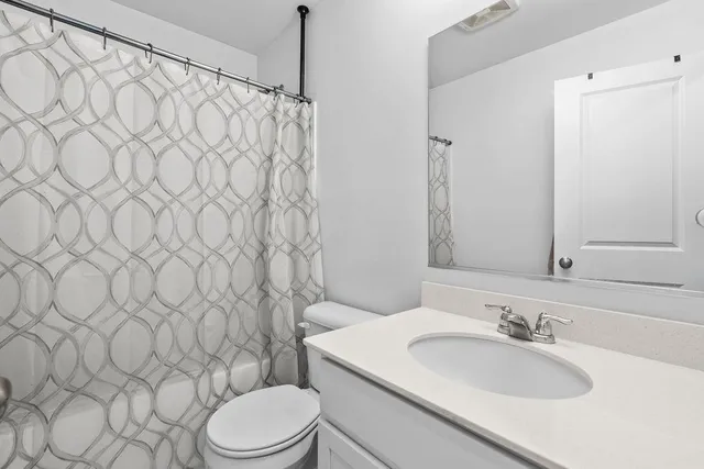 a living room with furniture and a ceiling fan