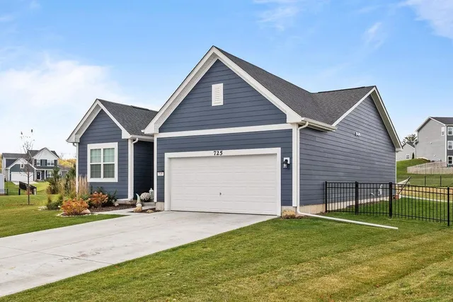 a living room with furniture and a flat screen tv with kitchen view