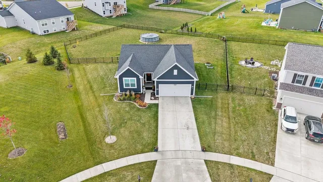a front view of a house with a yard and patio