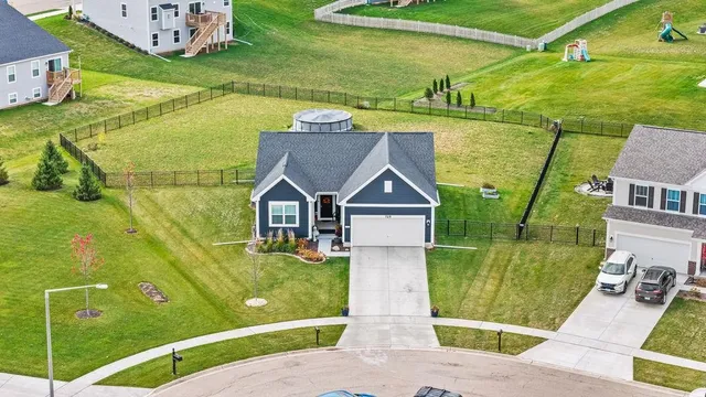 a view of backyard with swimming pool and outdoor seating