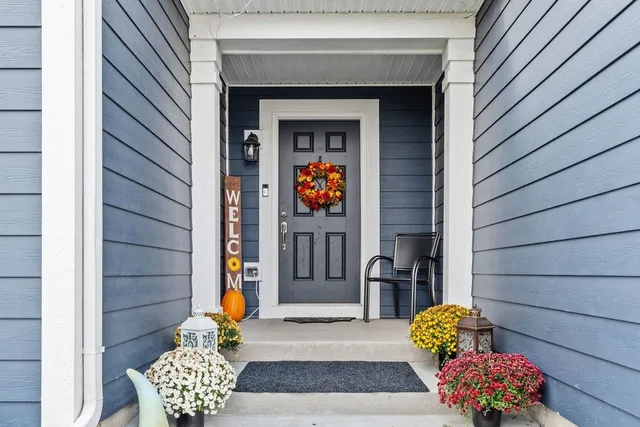 a living room with furniture and a chandelier