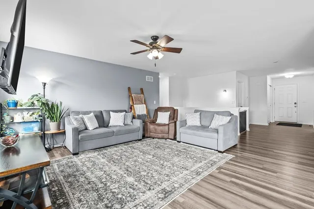 a kitchen with stainless steel appliances granite countertop white cabinets a stove a sink and dishwasher