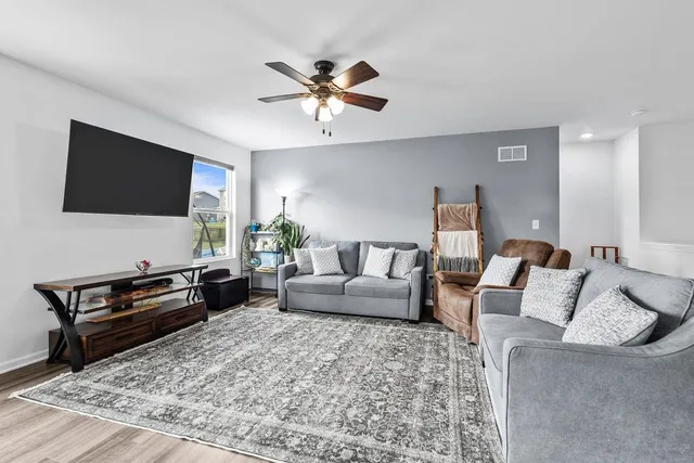 a kitchen with a table chairs sink and cabinets