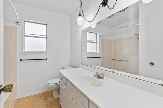 a bathroom with a sink a toilet and mirror