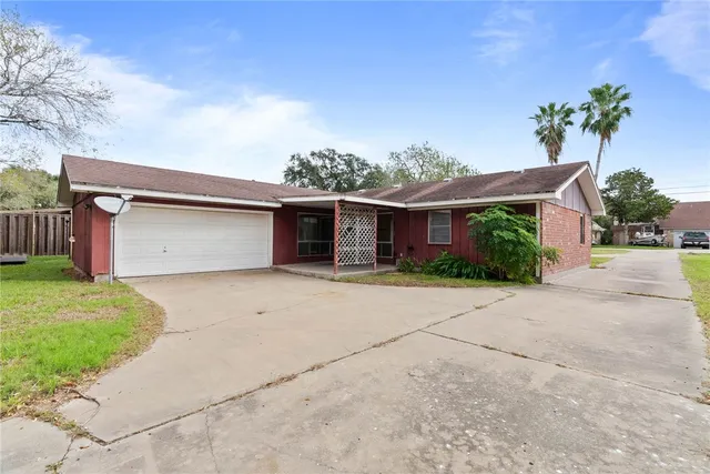 a front view of a house with a yard and a garage