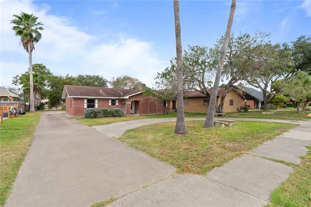 a house that has a tree in front of it