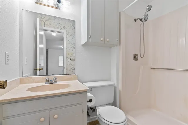 a bathroom with a sink toilet and shower