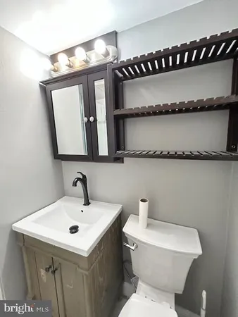 a bathroom with a sink a mirror and a toilet