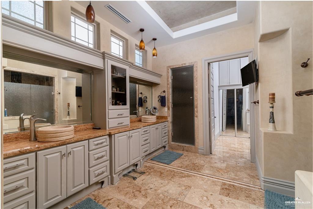 1205 Travis Street Mission, TX 78572 - Photo 15 of 45 a large bathroom with a double vanity sink and a mirror