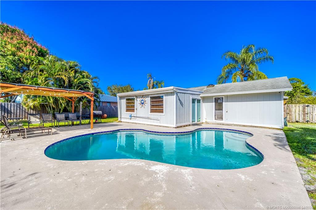 656 Southeast Ron Rico Terrace Port St. Lucie, FL 34983 - Photo 13 of 20 a view of a house with swimming pool