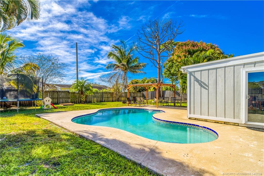 656 Southeast Ron Rico Terrace Port St. Lucie, FL 34983 - Photo 14 of 20 a view of a swimming pool with a patio