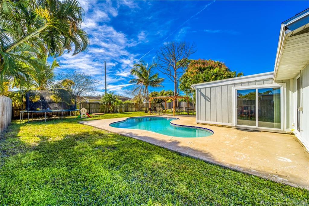 656 Southeast Ron Rico Terrace Port St. Lucie, FL 34983 - Photo 15 of 20 a view of a house with swimming pool and sitting area