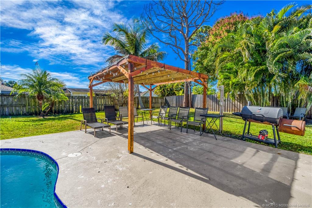 656 Southeast Ron Rico Terrace Port St. Lucie, FL 34983 - Photo 17 of 20 a view of a backyard with a garden and entertaining space
